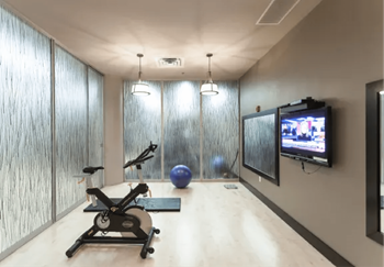 a workout room with a tv and a exercise bike  at The Cosmopolitan, St Paul, Minnesota